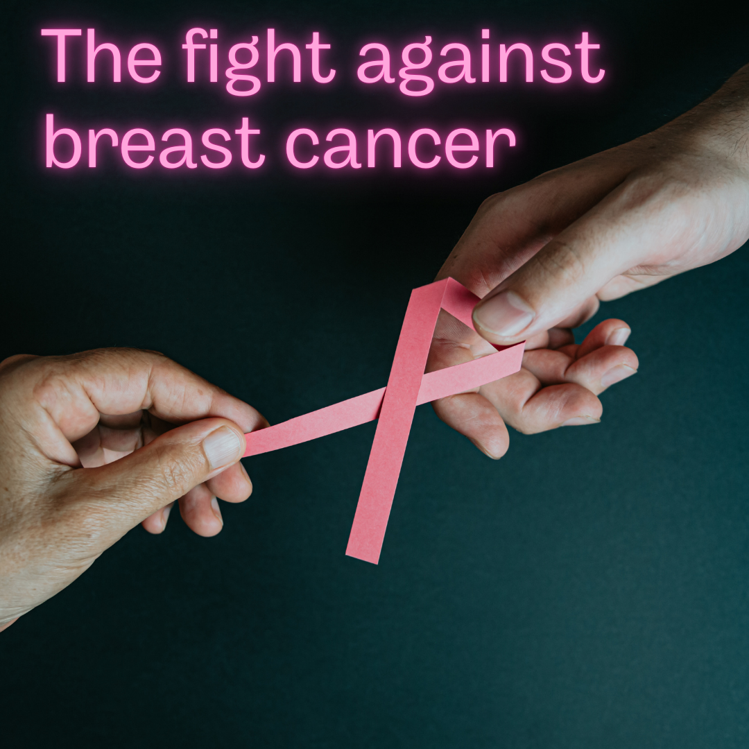A breast cancer ribbon being held by hands