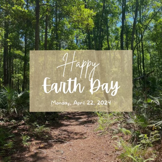 A forest with the words Happy Earth Day overlayed