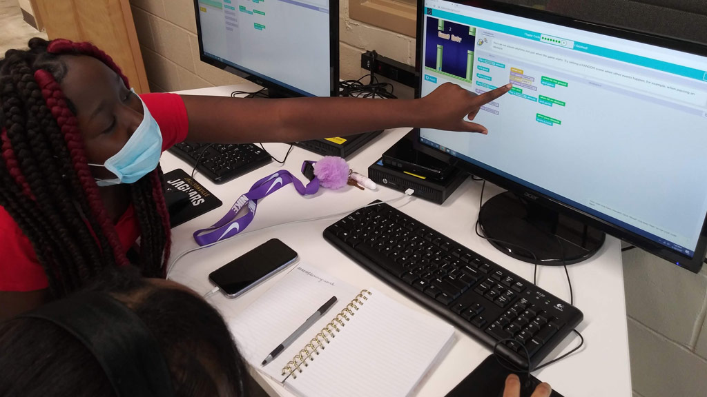 A person pointing at a computer screen